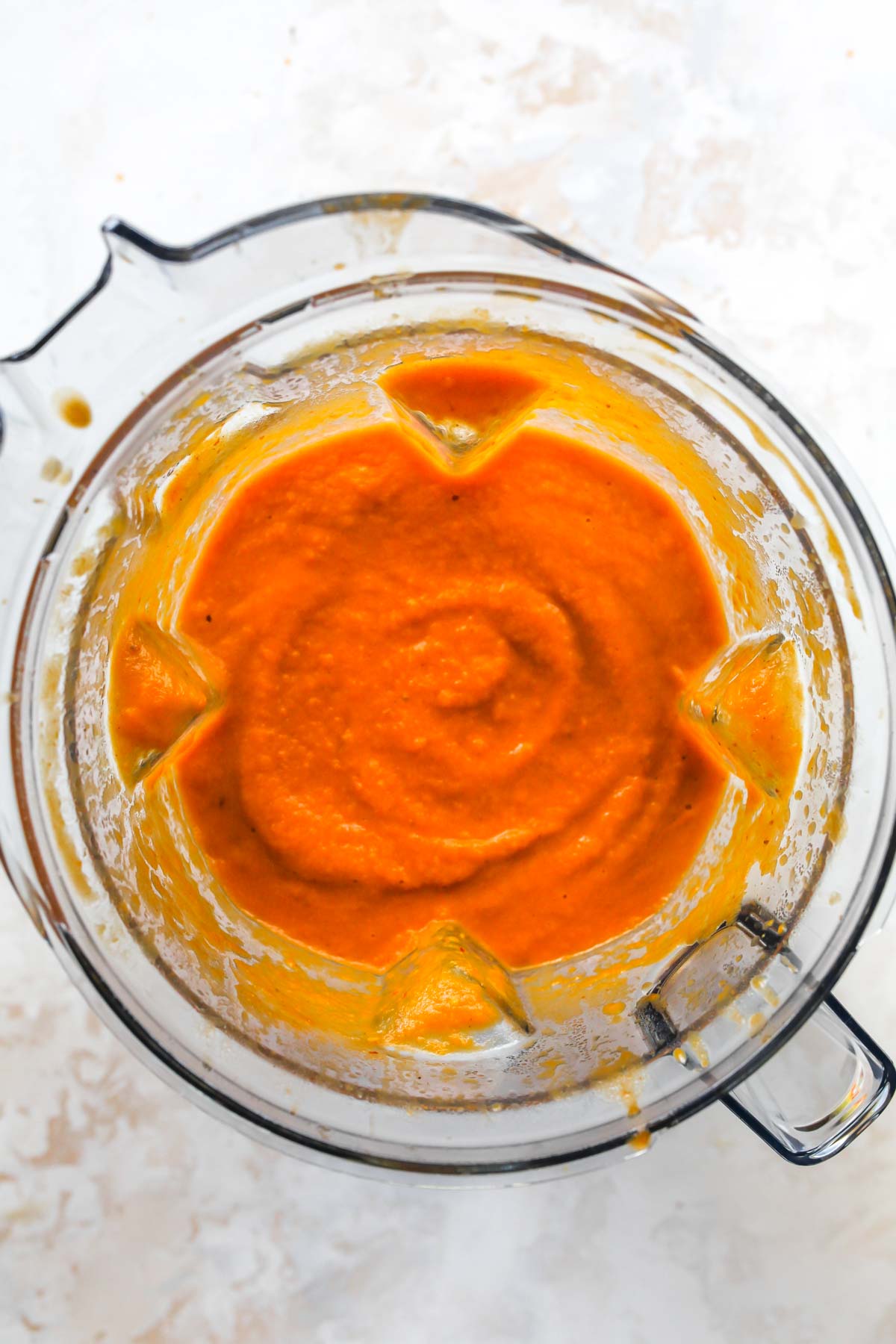Pumpkin soup being blended in a blender