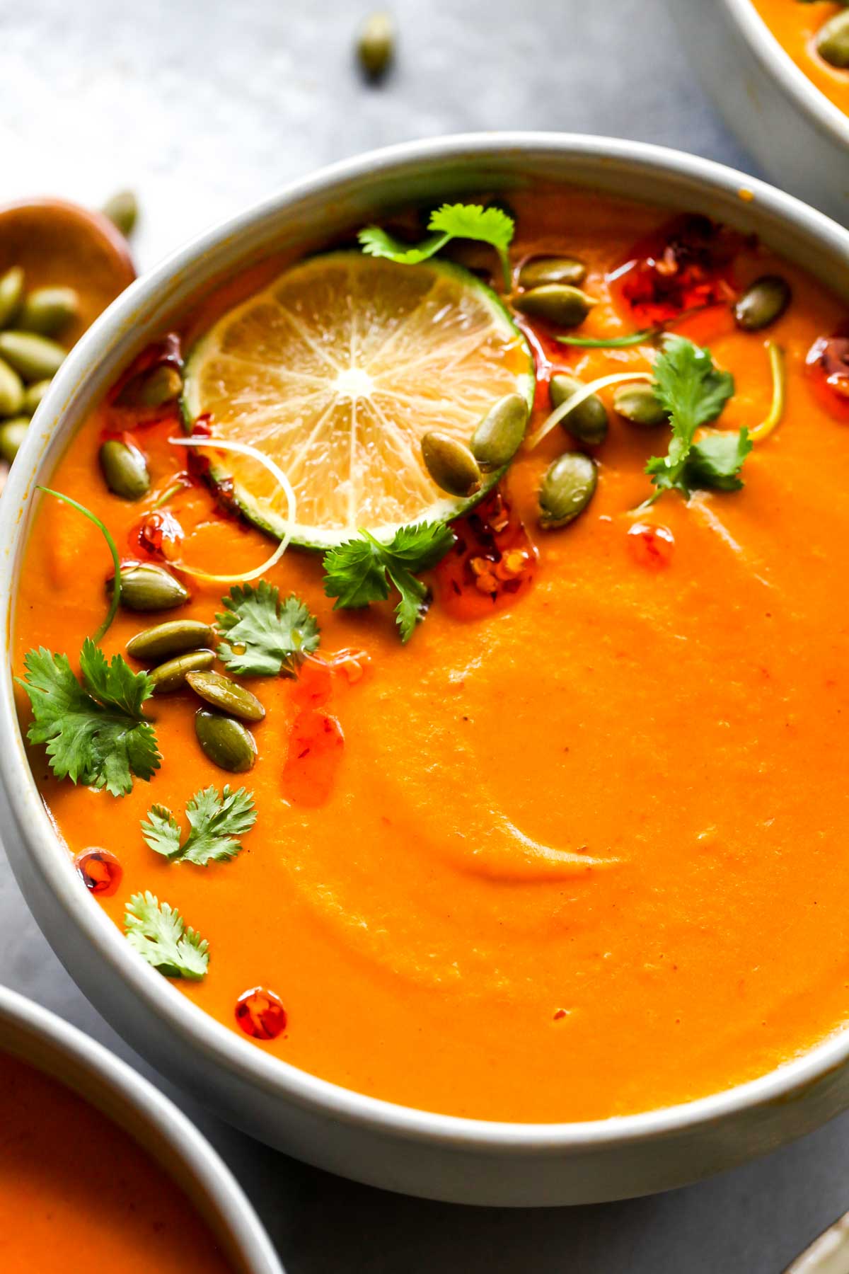 Vegan pumpkin soup topped with a lime wedge