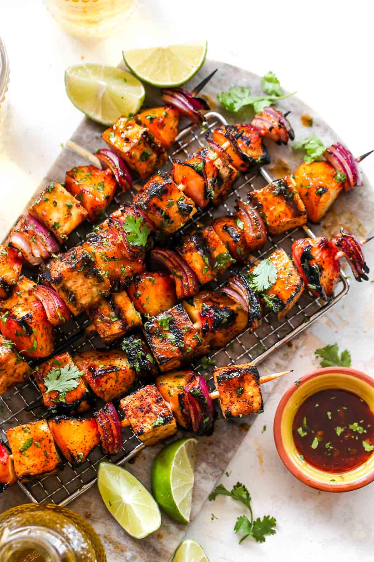 Veggie kebabs on a cutting board topped with chili glaze