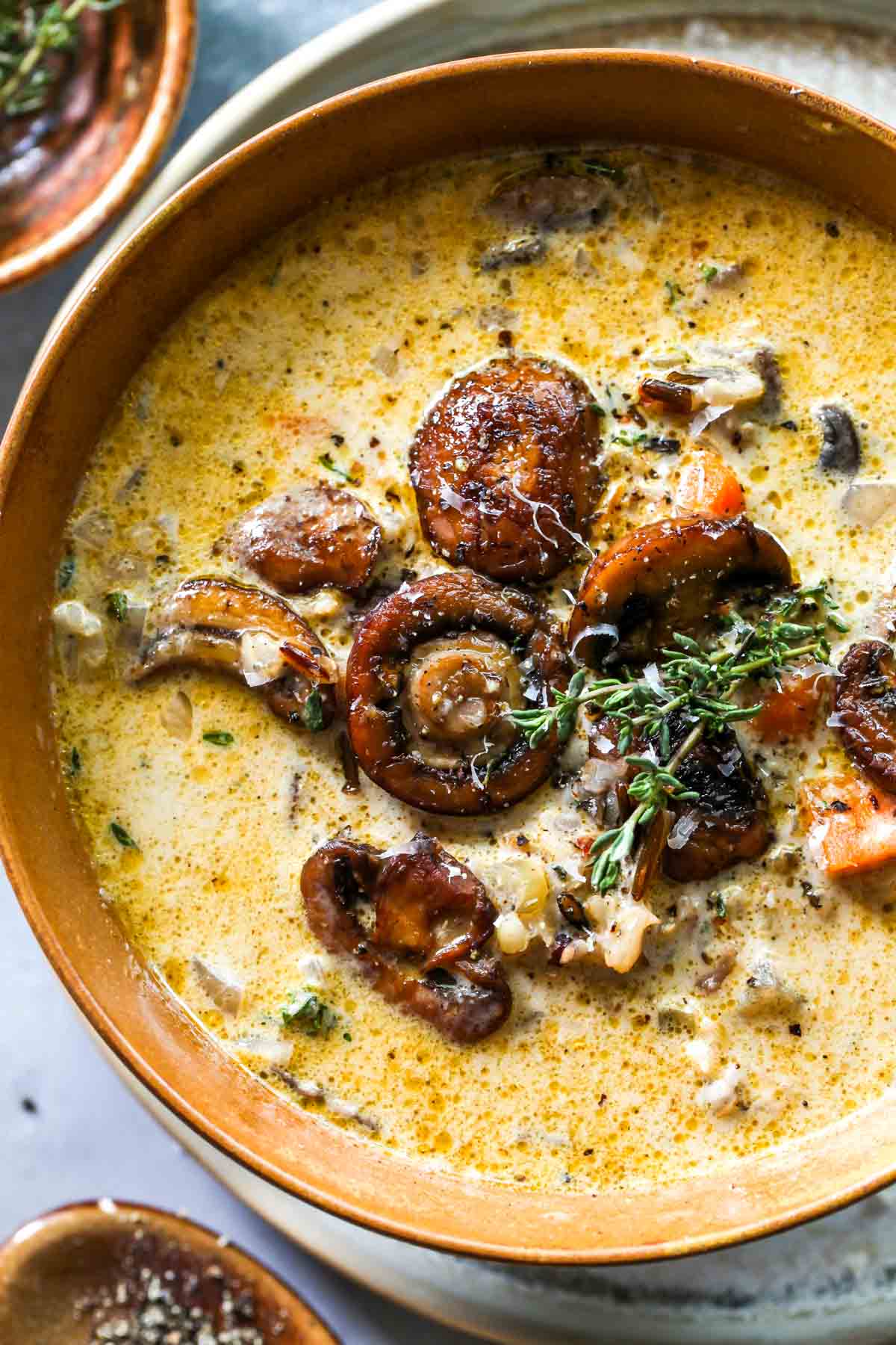Seared mushrooms on top of creamy rice soup