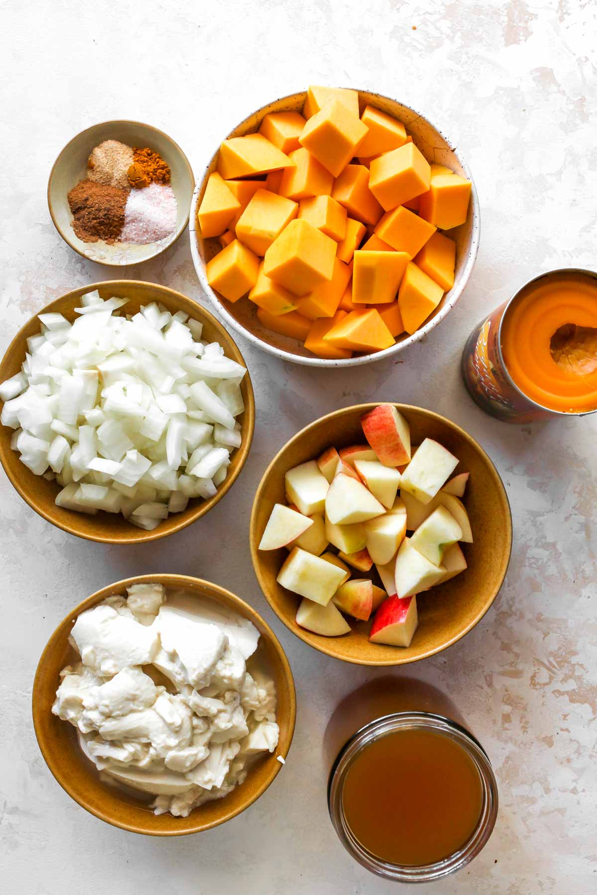 Recipe ingredients in separate bowls on a white surface