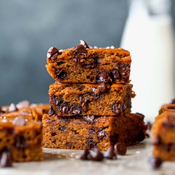 Chocolate chip pumpkin bars stacked on a cutting board