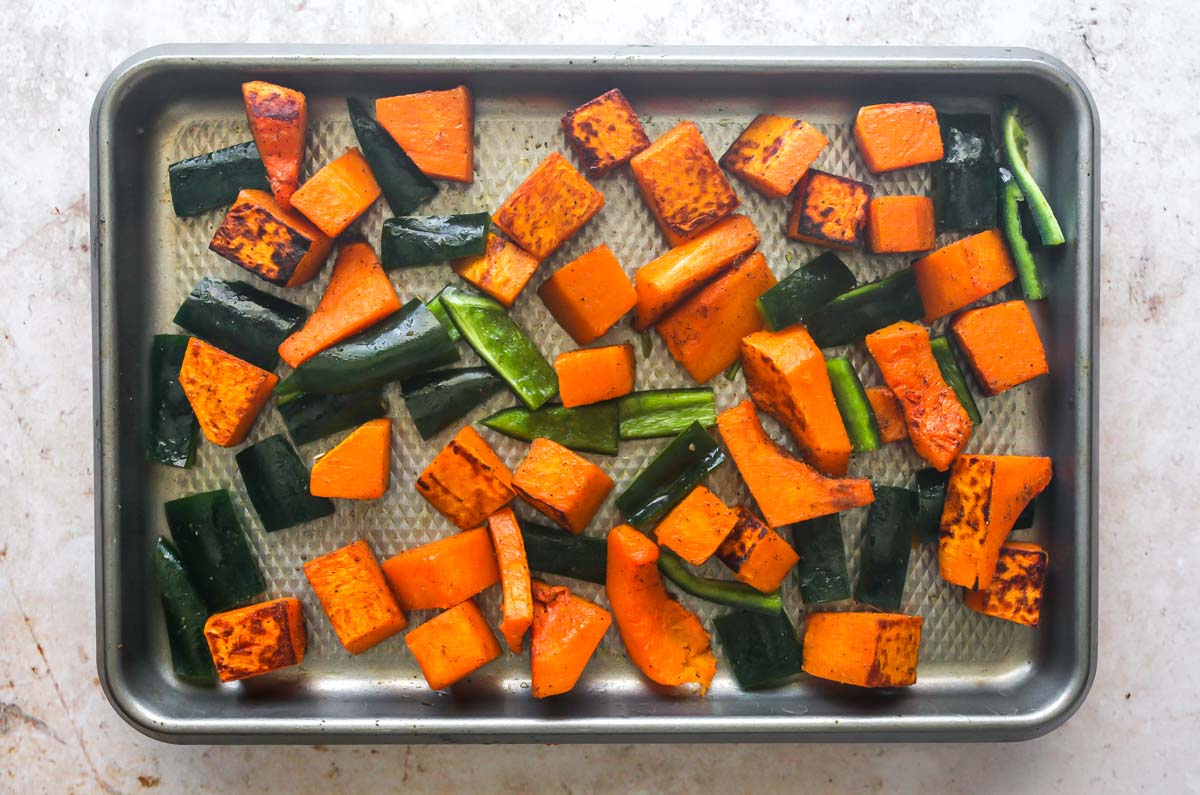 Peppers and squash on a silver baking sheet