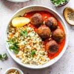Lentil meatballs in roasted red pepper sauce with pearl couscous