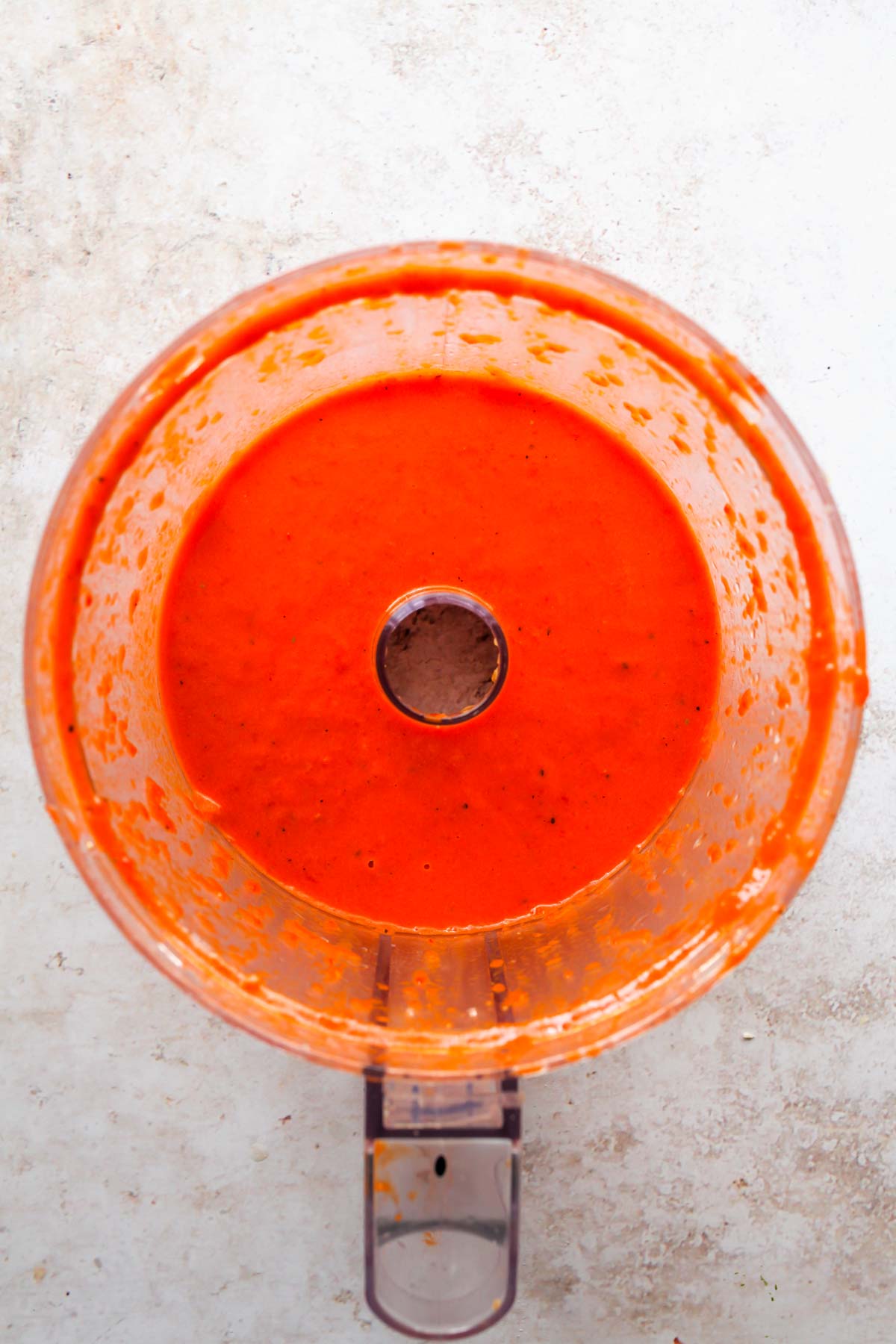 Roasted red pepper sauce being blended in a food processor