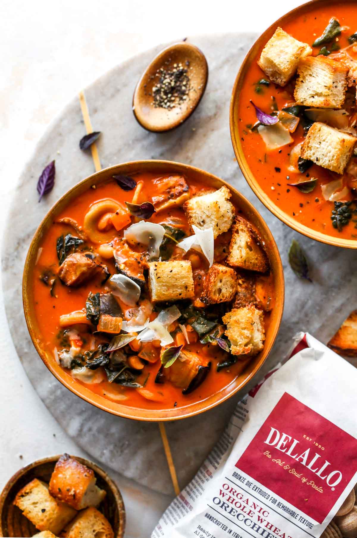 DeLallo pasta bag next to a bowl of soup