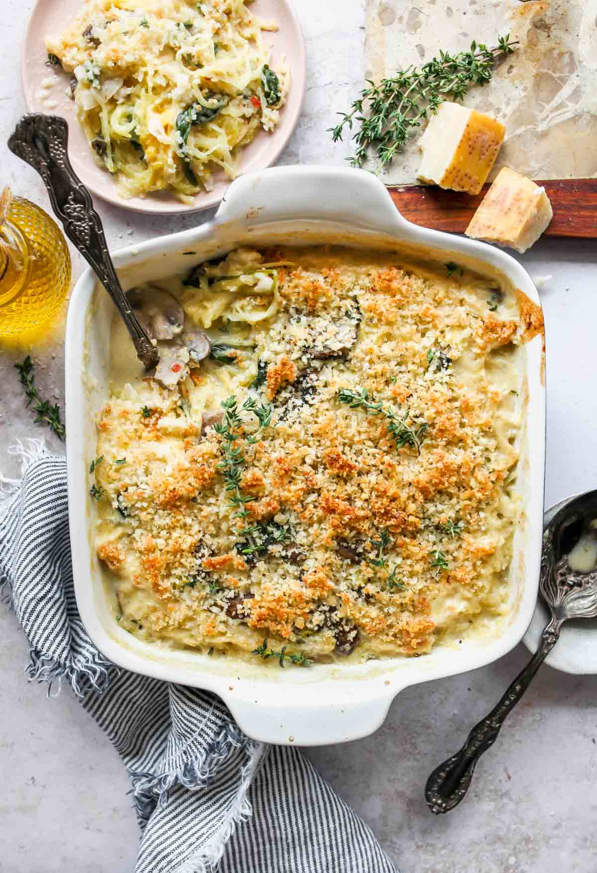 Spaghetti Squash Casserole in a white pan with a serving spoon resting on the side