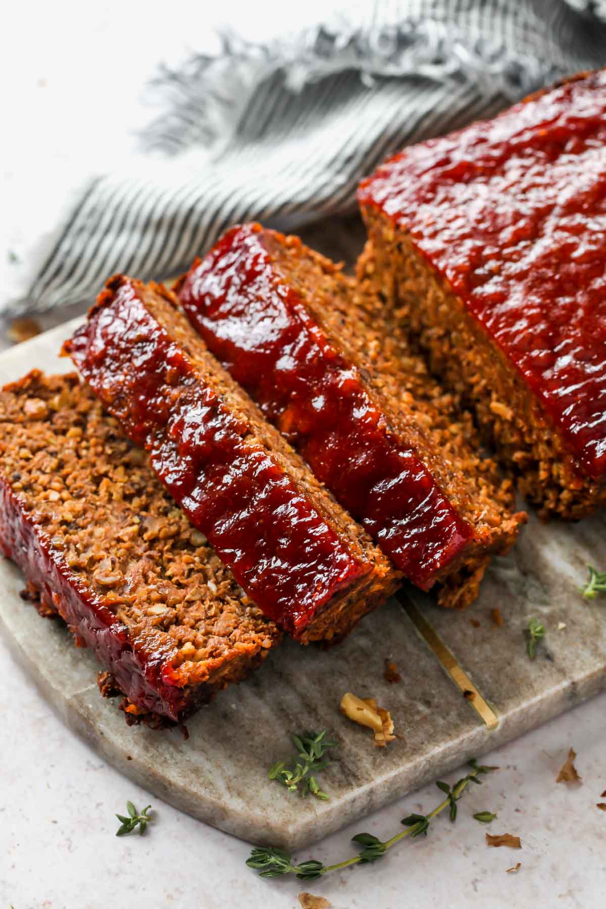 Three slices of vegan meatloaf on a cutting board
