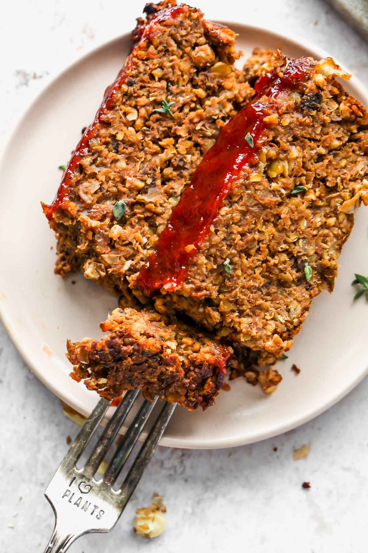 A fork cutting into a piece of mushroom lentil loaf