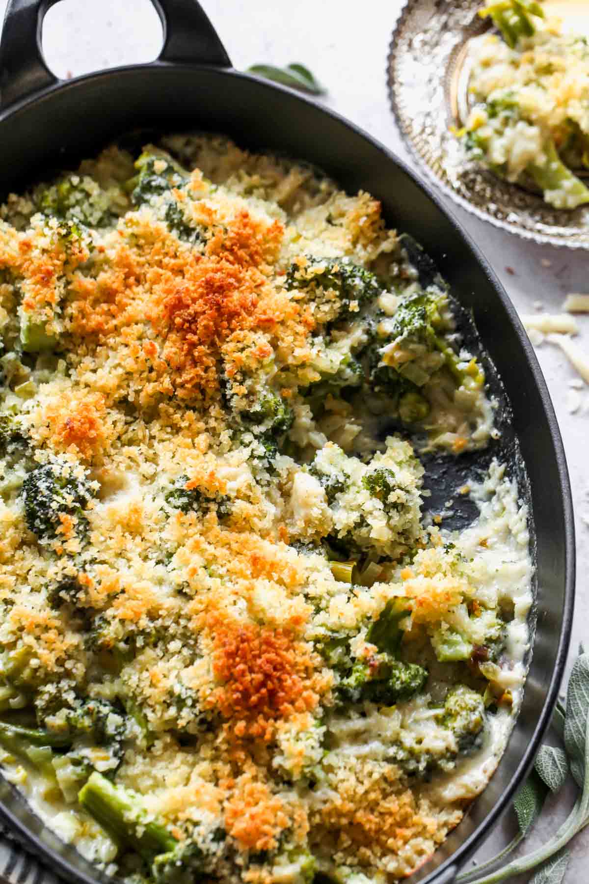 Broccoli Cheese Casserole with panko topping in a black baking dish.