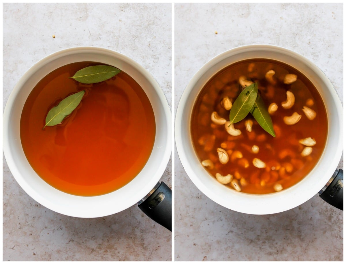 Broth, bay leaves, and cashews simmering in a pot.