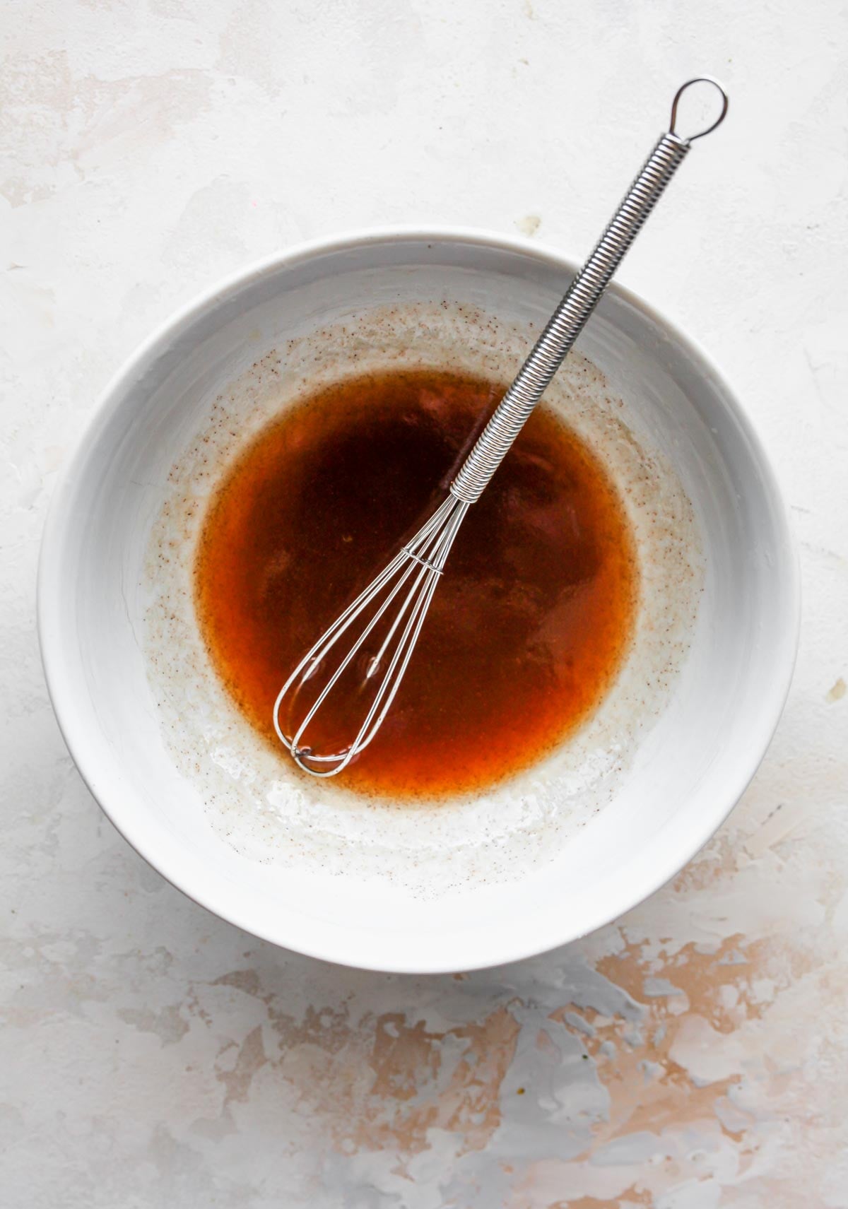 Butter and maple syrup being whisked in a bowl
