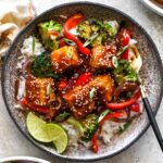 Orange tofu served with rice and veggies