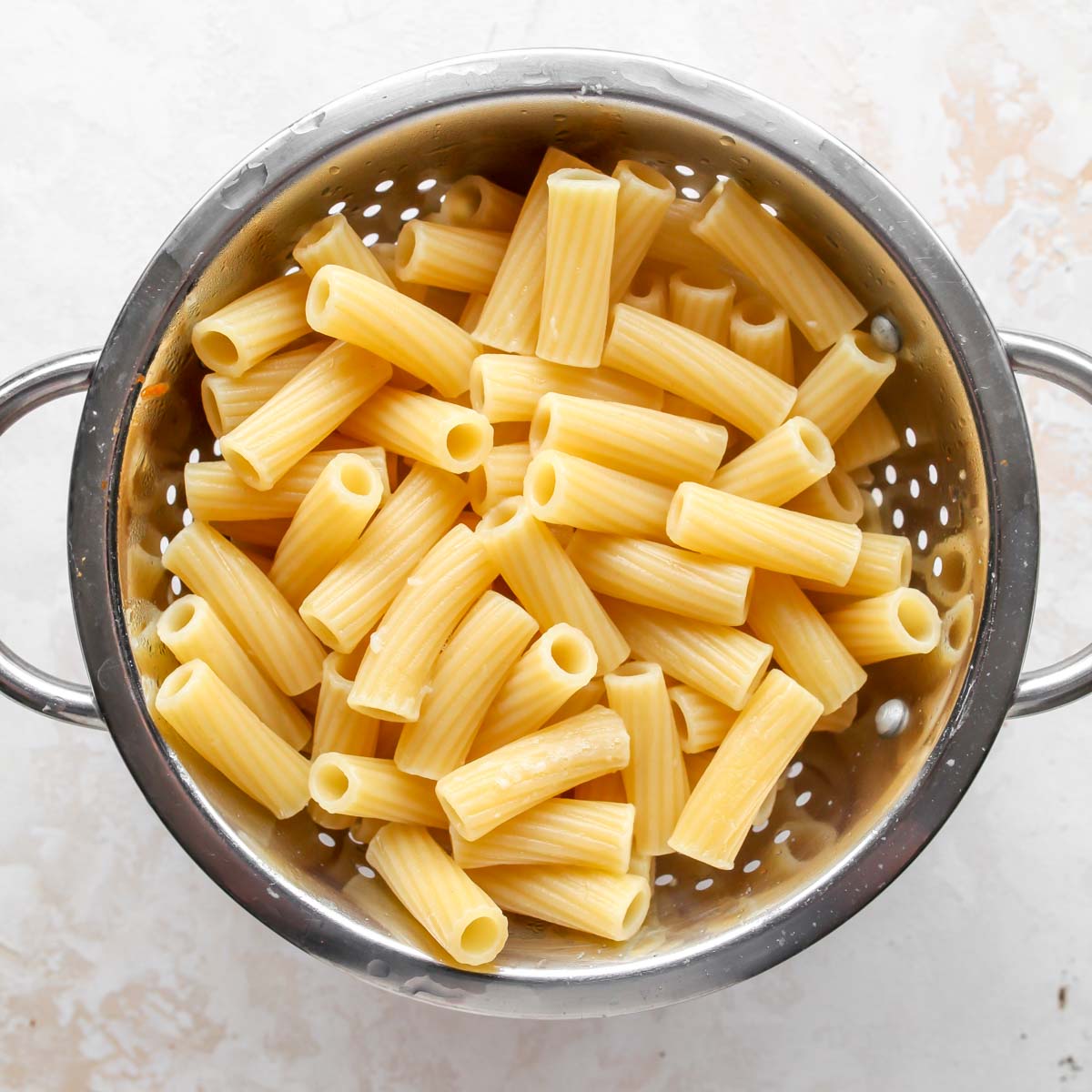 Cooked rigatoni in a strainer