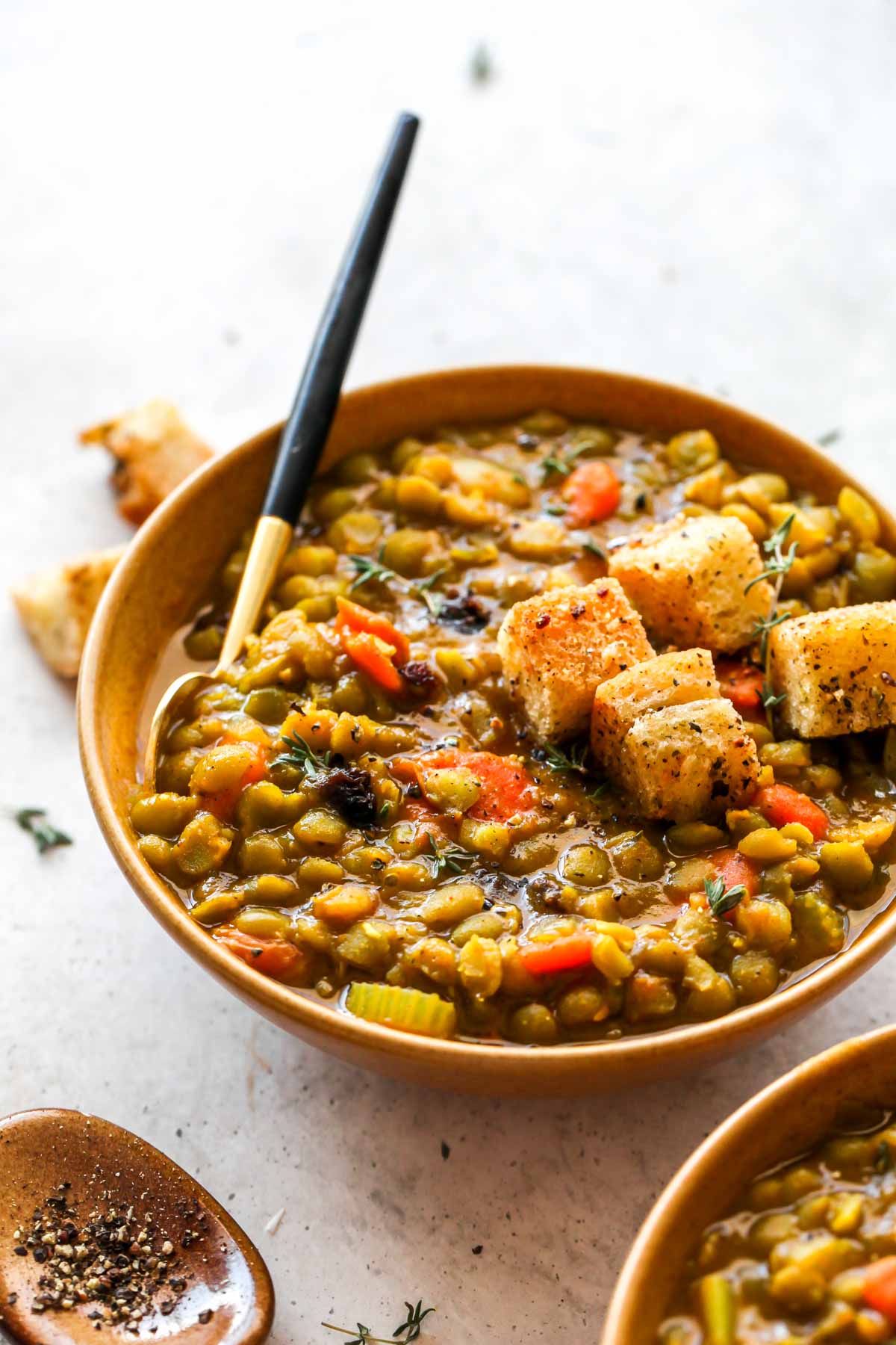 Moroccan Split Pea Soup served with raisins in a gold bowl