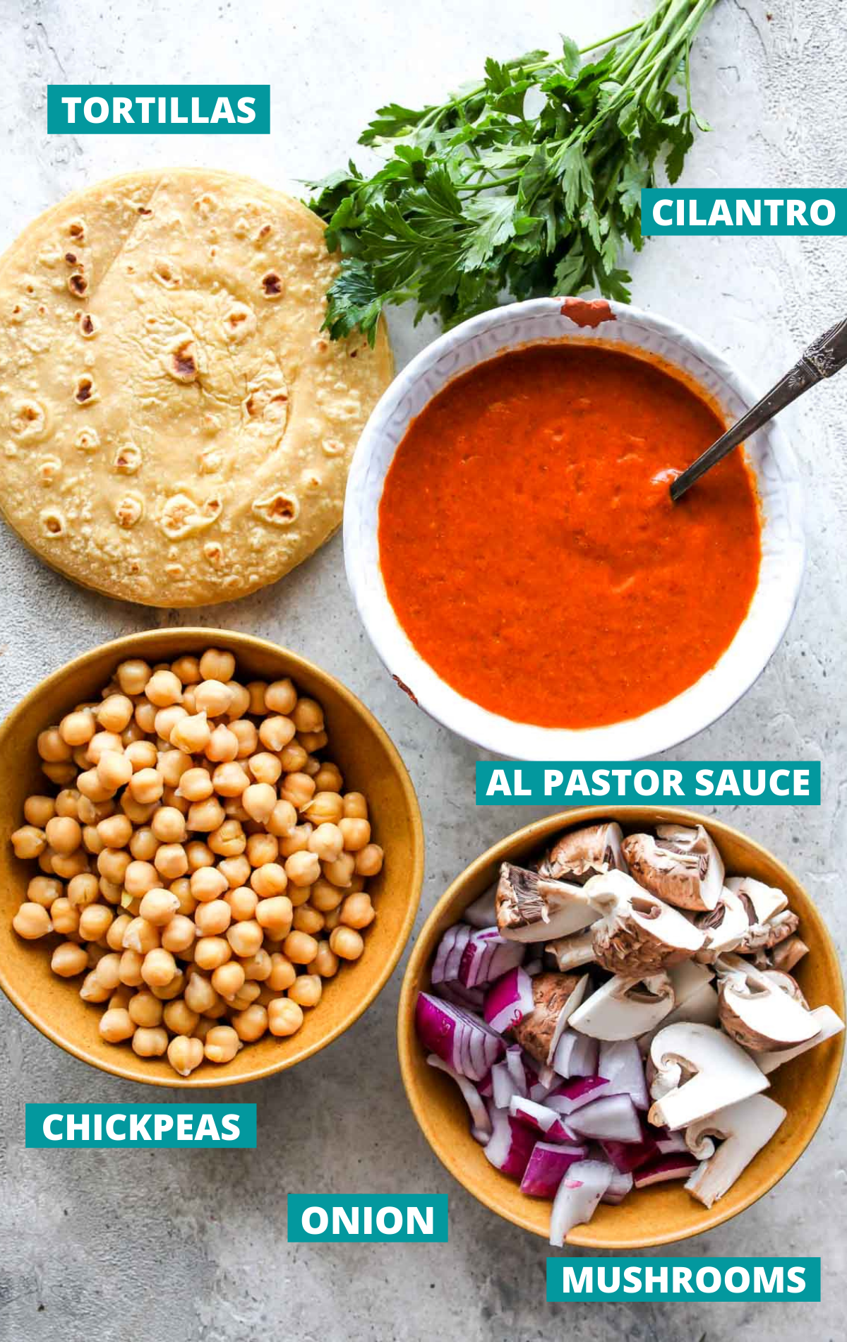 Chickpea taco ingredients in separate bowls with blue labels