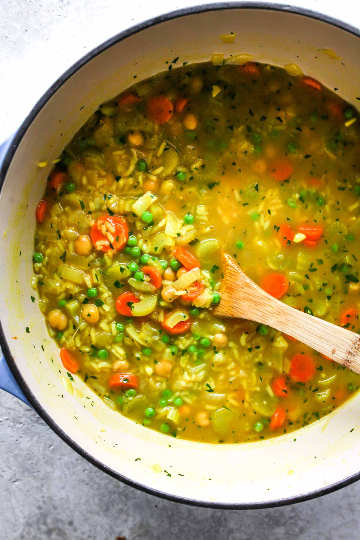 Vegetarian chickpea soup being stirred after cooking