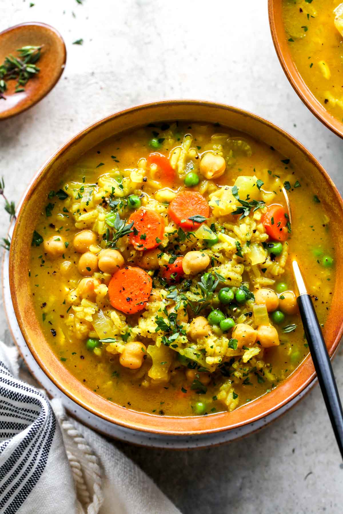 Gold bowl filled with chickpea and rice soup