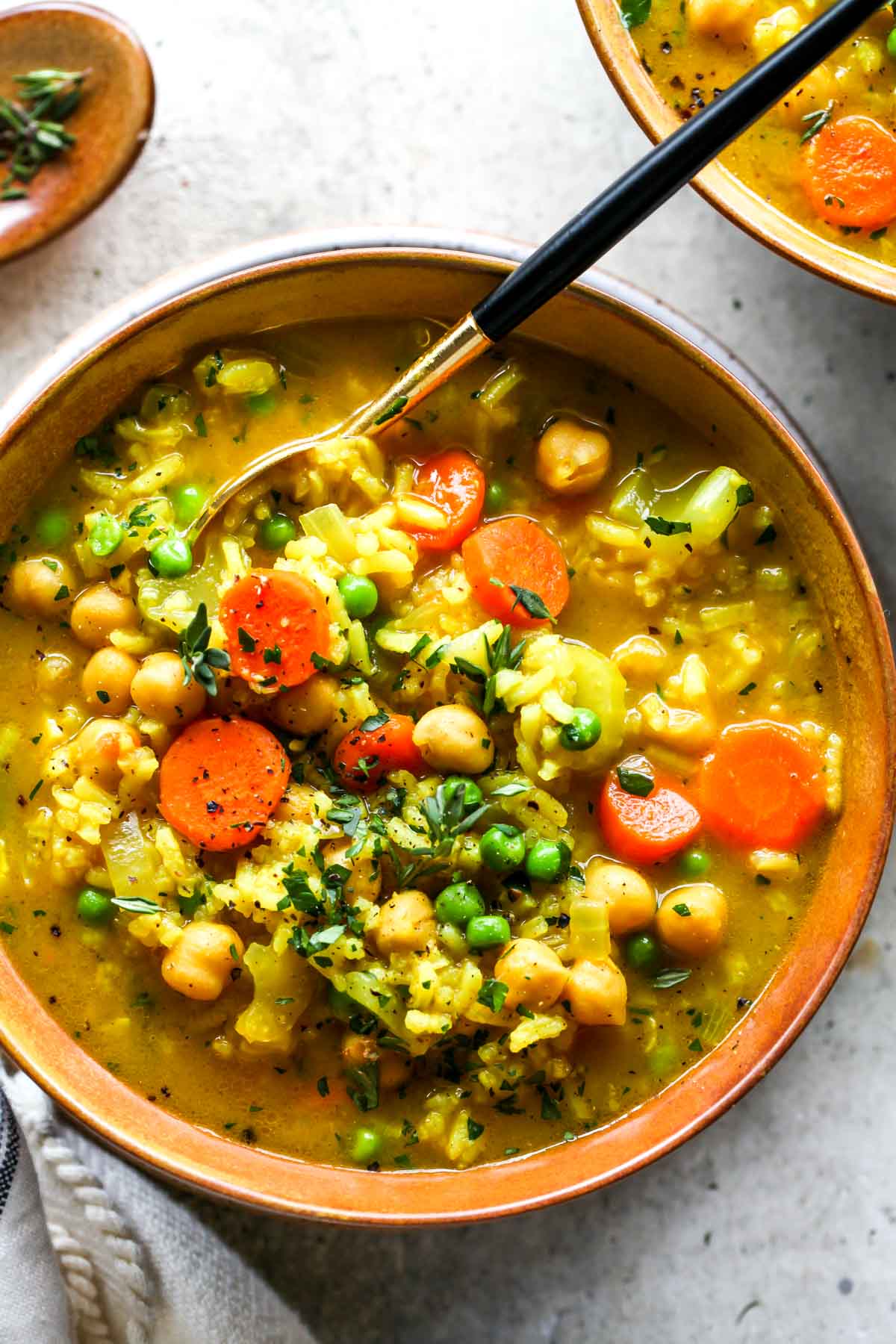 Chickpea and rice soup with a spoon removing a spoonful
