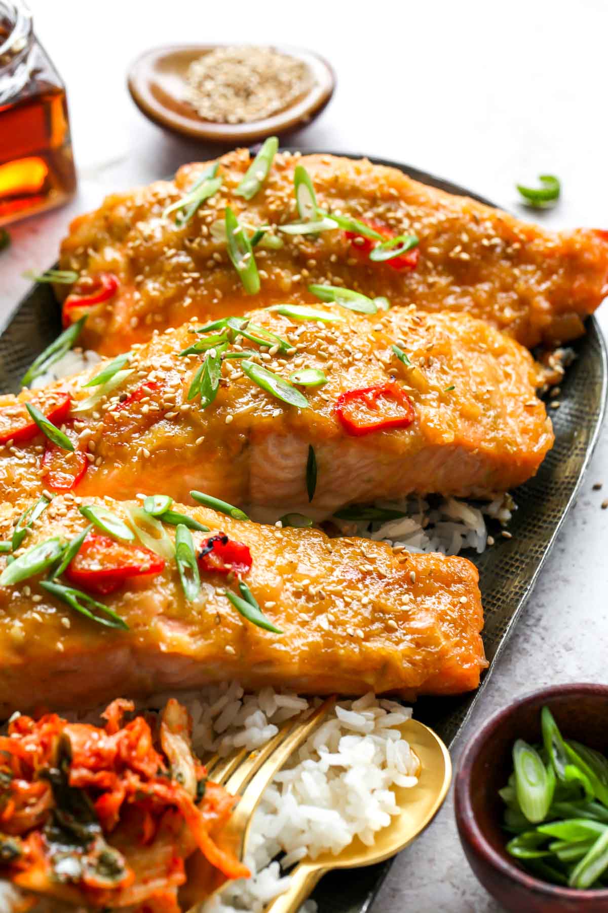 Close up showing flaky salmon fillets on a platter of rice