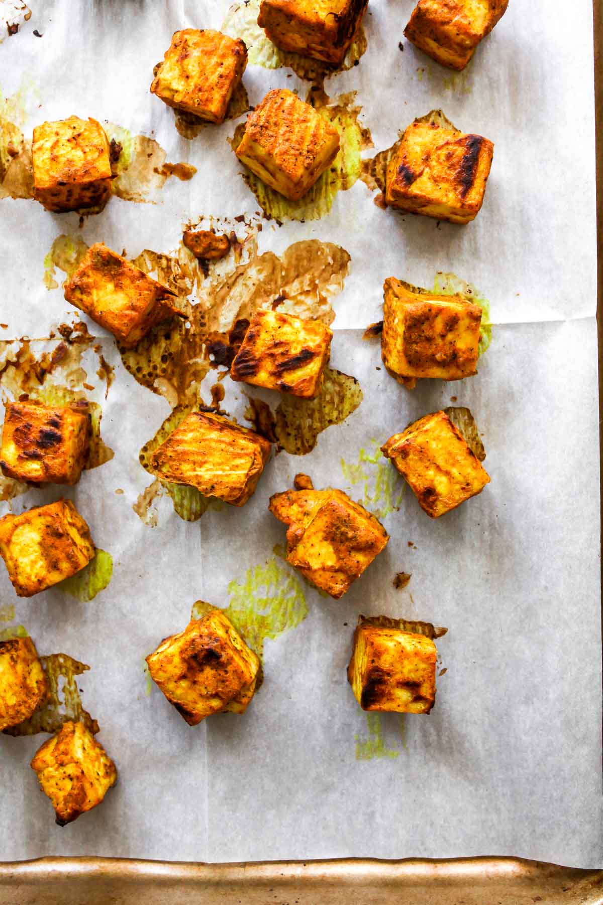 Close up of marinated baked tofu on a baking sheet