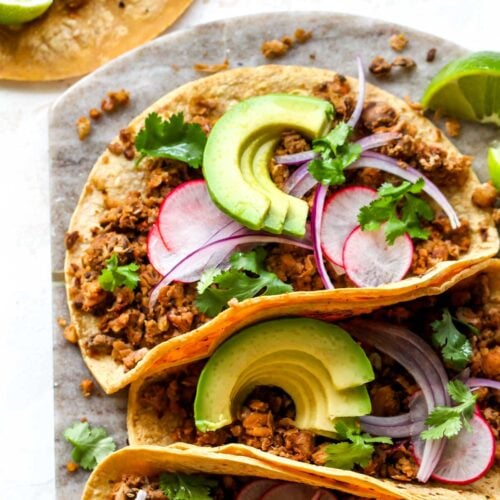 Vegan chorizo tacos topped with avocado and cilantro