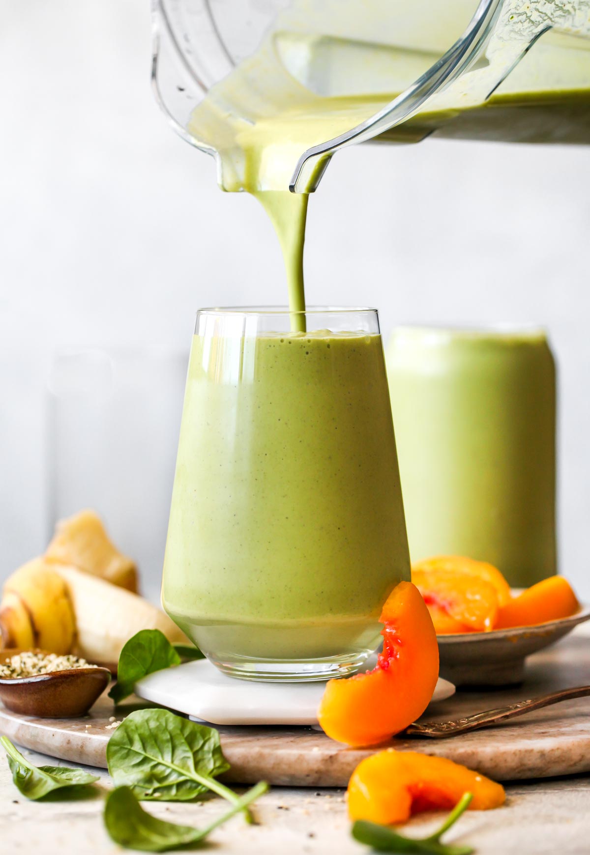 Smoothie being poured from the blender into a serving glass