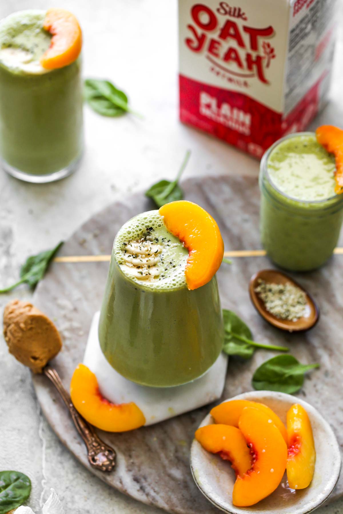 Smoothies on a serving platter with Silk Oat Milk in the background
