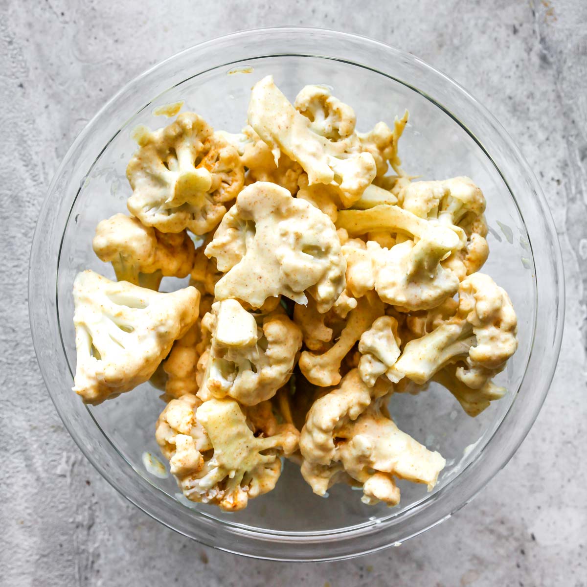 Cauliflower florets marinating in coconut milk and spices