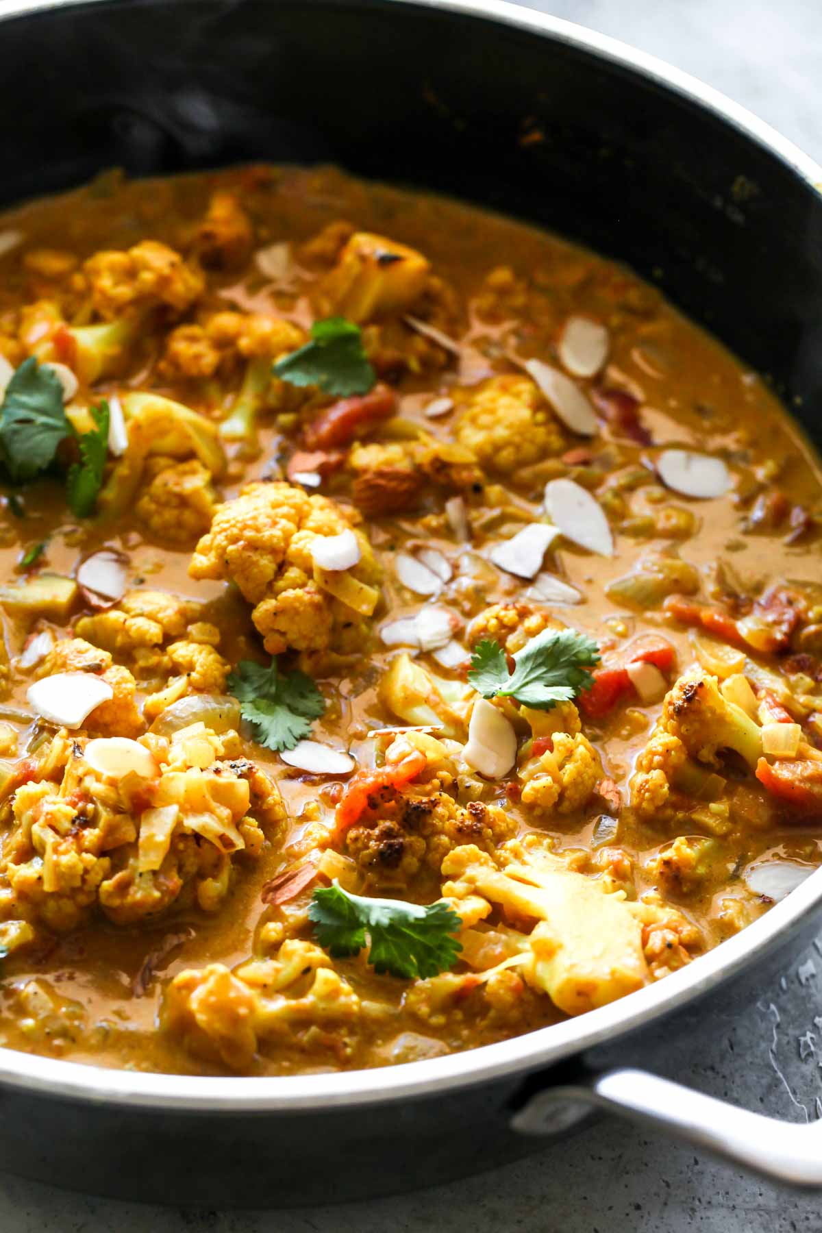 Vegetable korma simmering in a saute pan