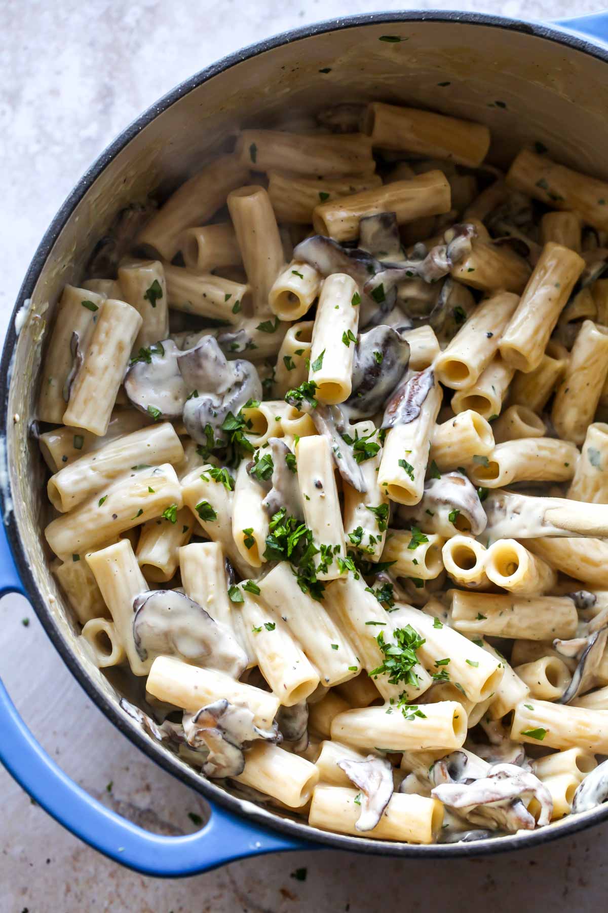 Vegan mushroom pasta in a Dutch oven topped with parsley