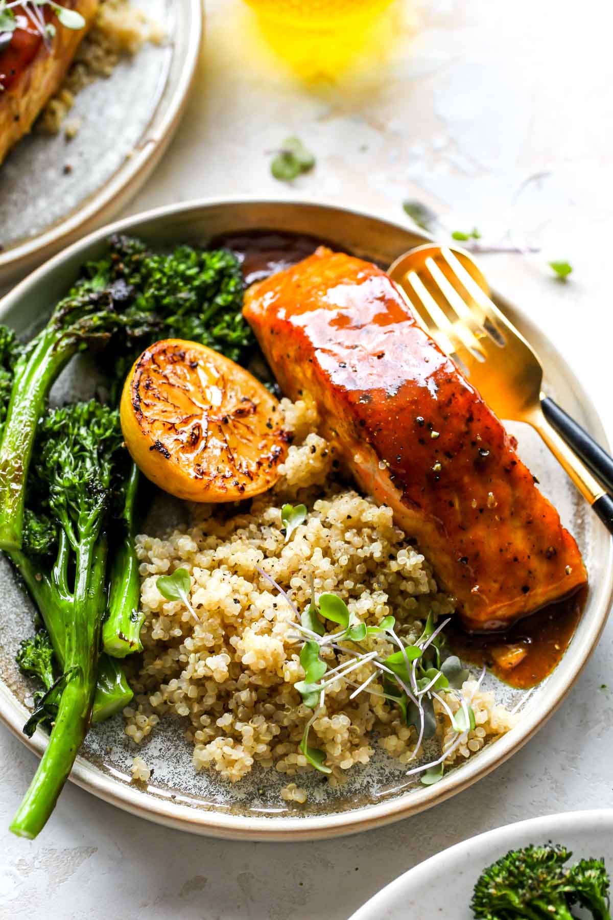 Maple-glazed salmon on a plate with quinoa and broccoli