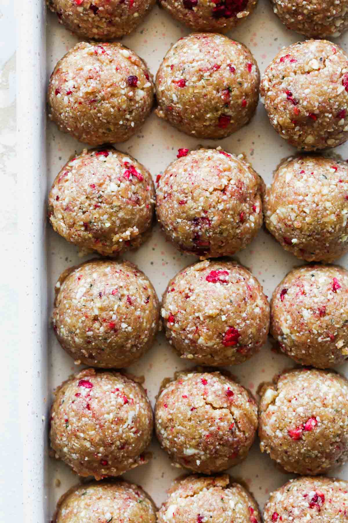 Energy bites rolled into balls and lined up on a baking sheet