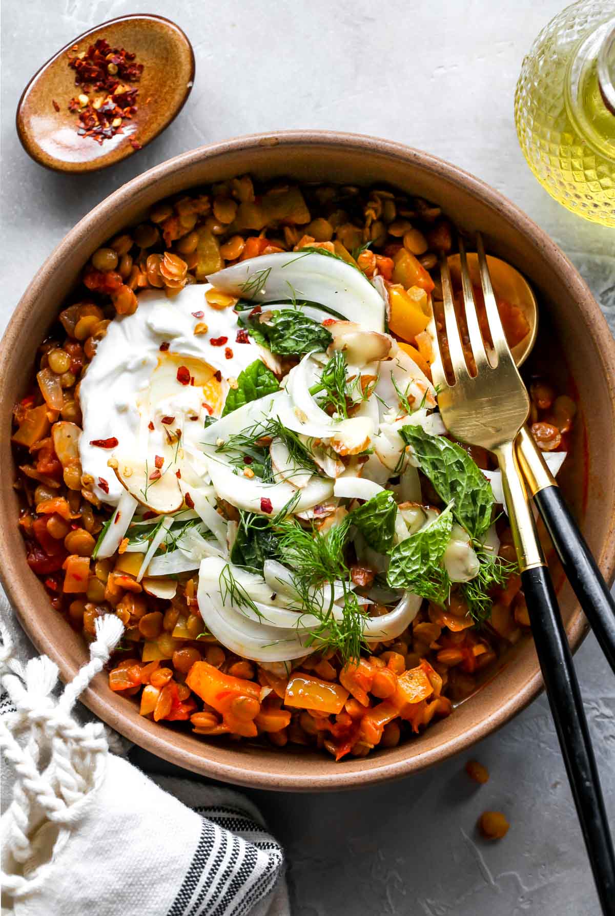 A bowl of harissa lentils with fennel slaw and a dollop of yogurt