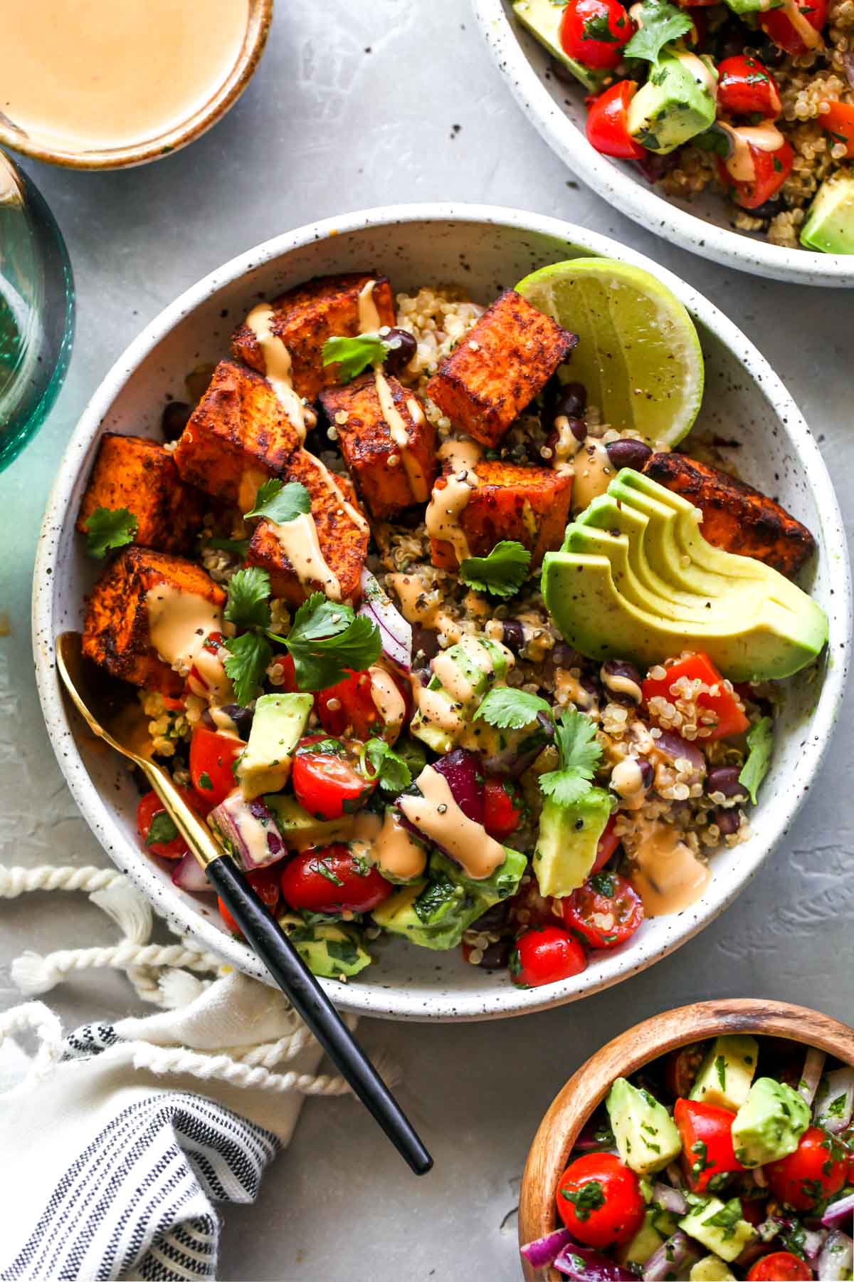 Sweet potato vegetarian burrito bowls topped with tahini sauce