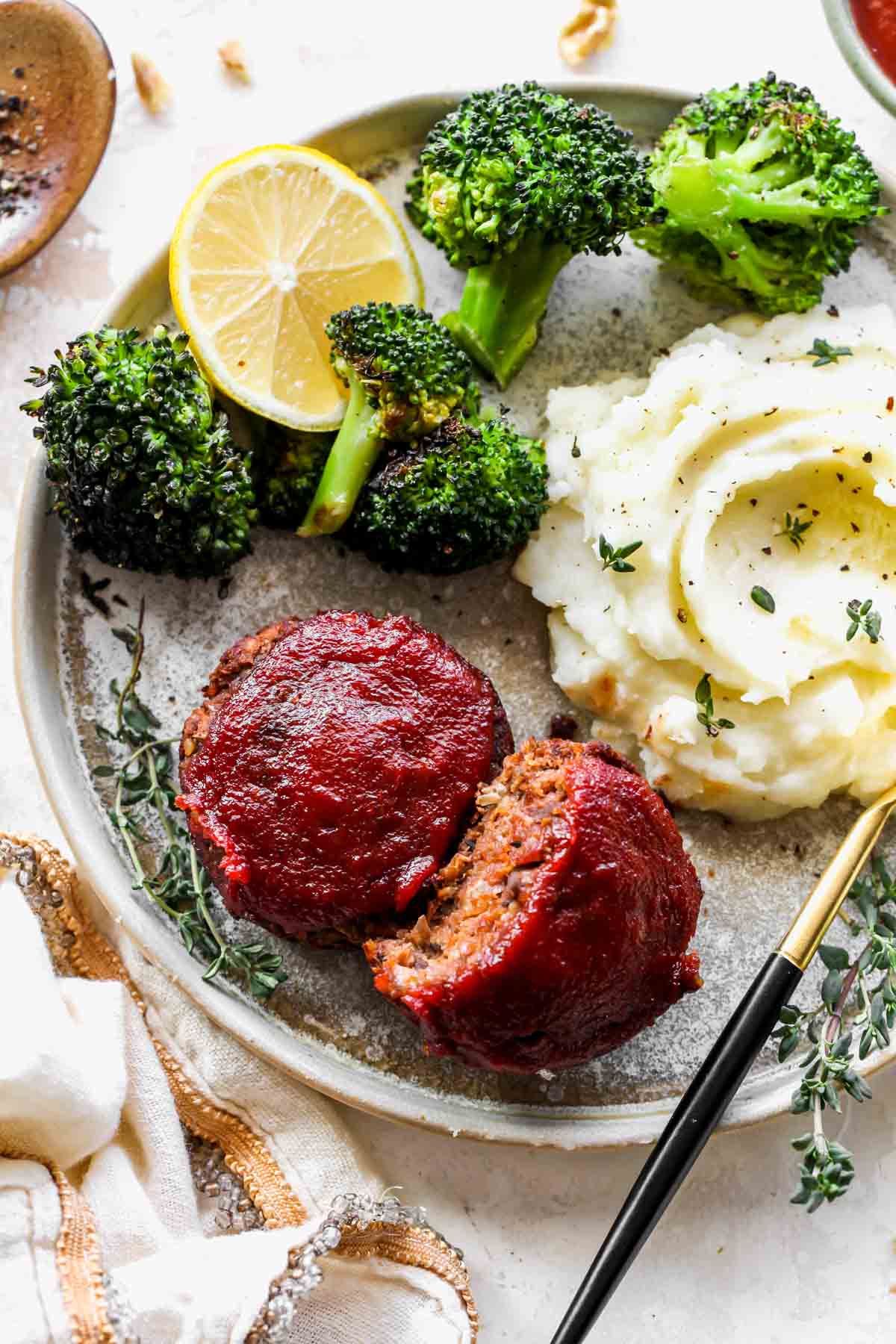 Vegetarian meatloaf minis on a plate with mashed potatoes and broccoli