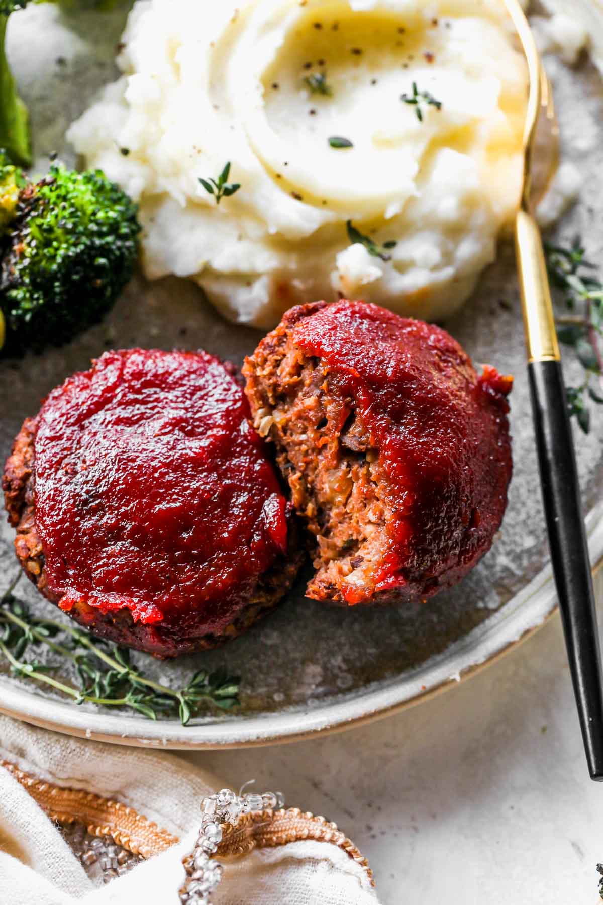 Vegetarian meatloaf mini being sliced into on a plate