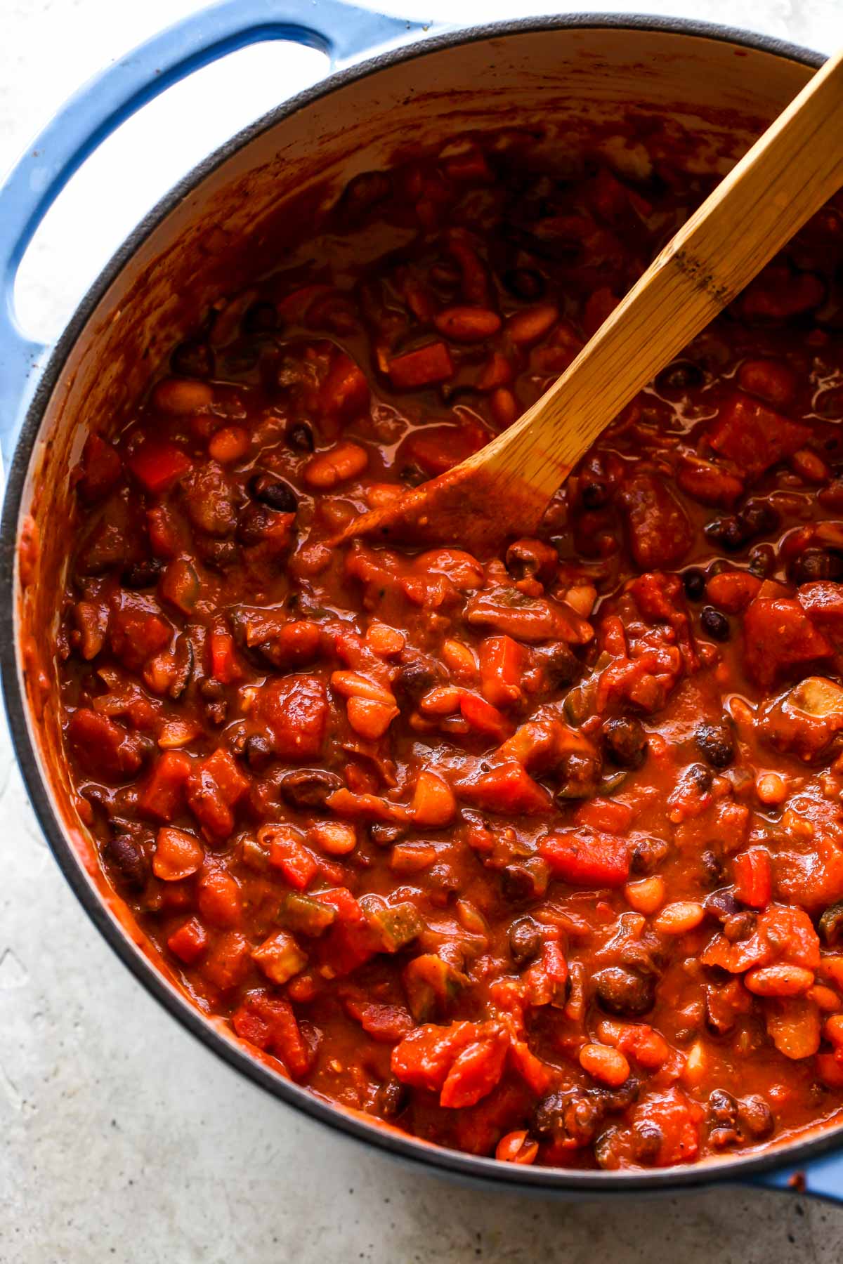 Spoon stirring mole poblano chili after being simmered