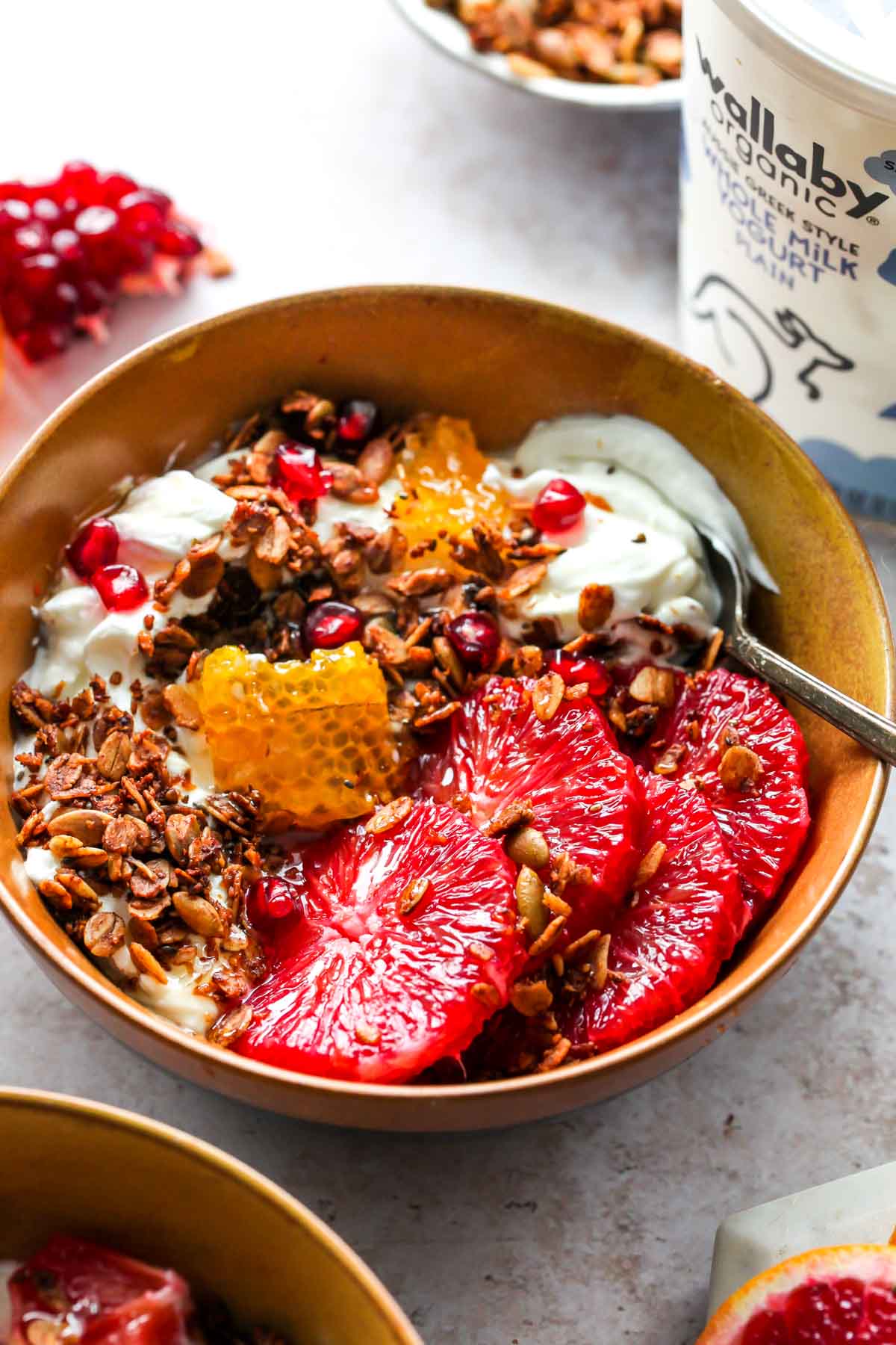 Protein granola served over yogurt with orange slices