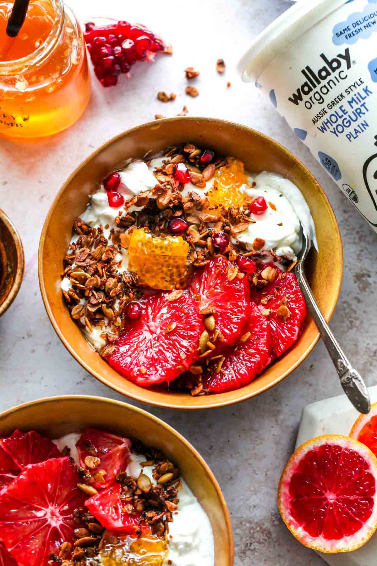 Breakfast spread including Wallaby yogurt, honey, citrus, and prepared breakfast bowls