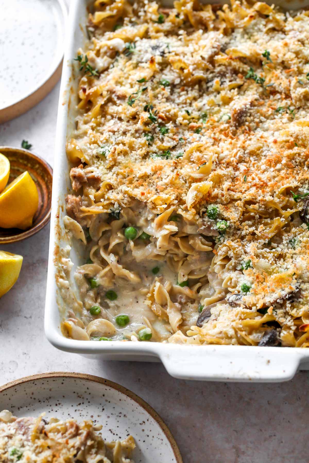 Homemade Tuna Noodle Casserole in a white dish with a serving scooped out