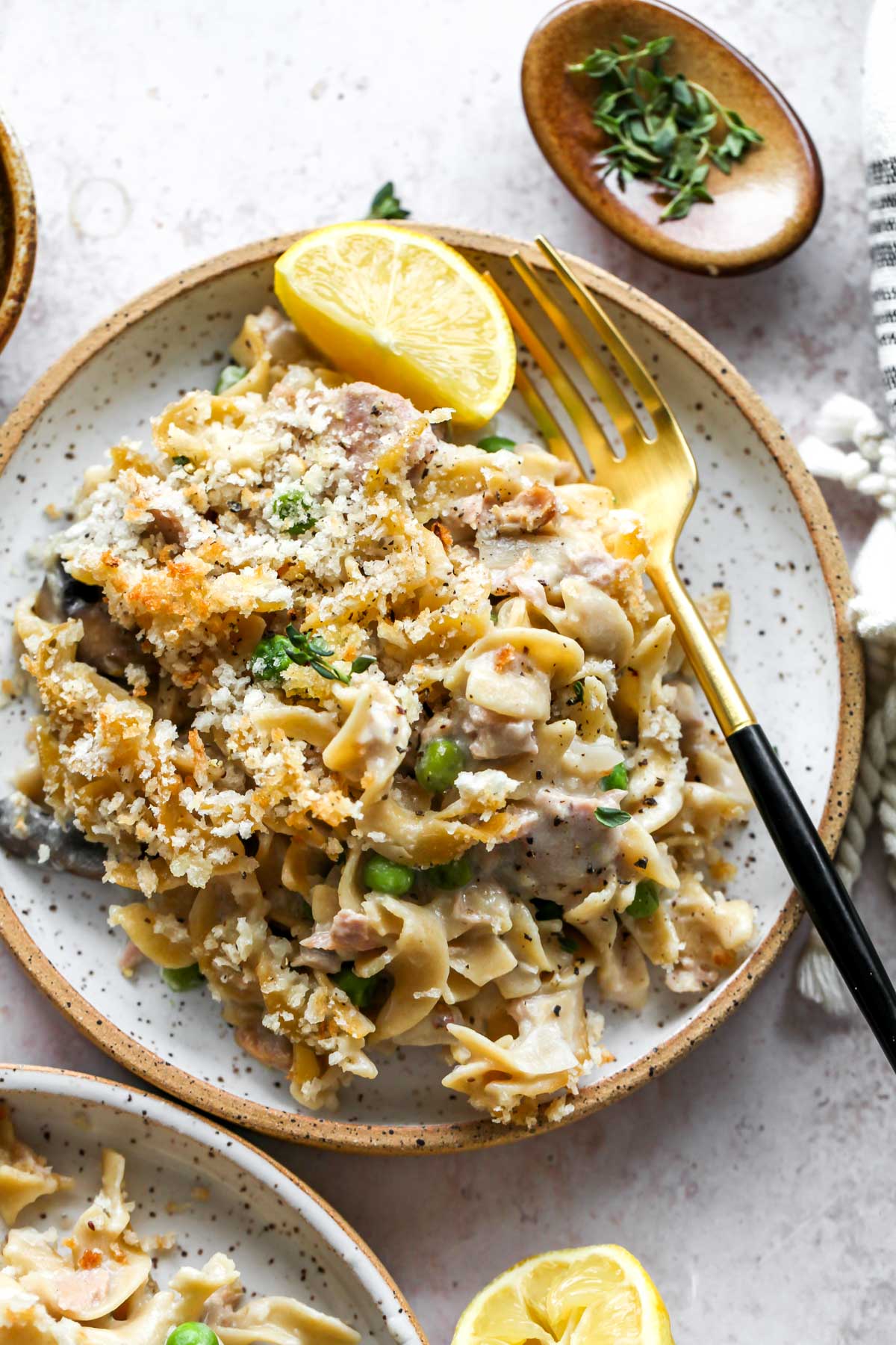 Single serving of tuna noodle bake on a small plate with a fork digging in