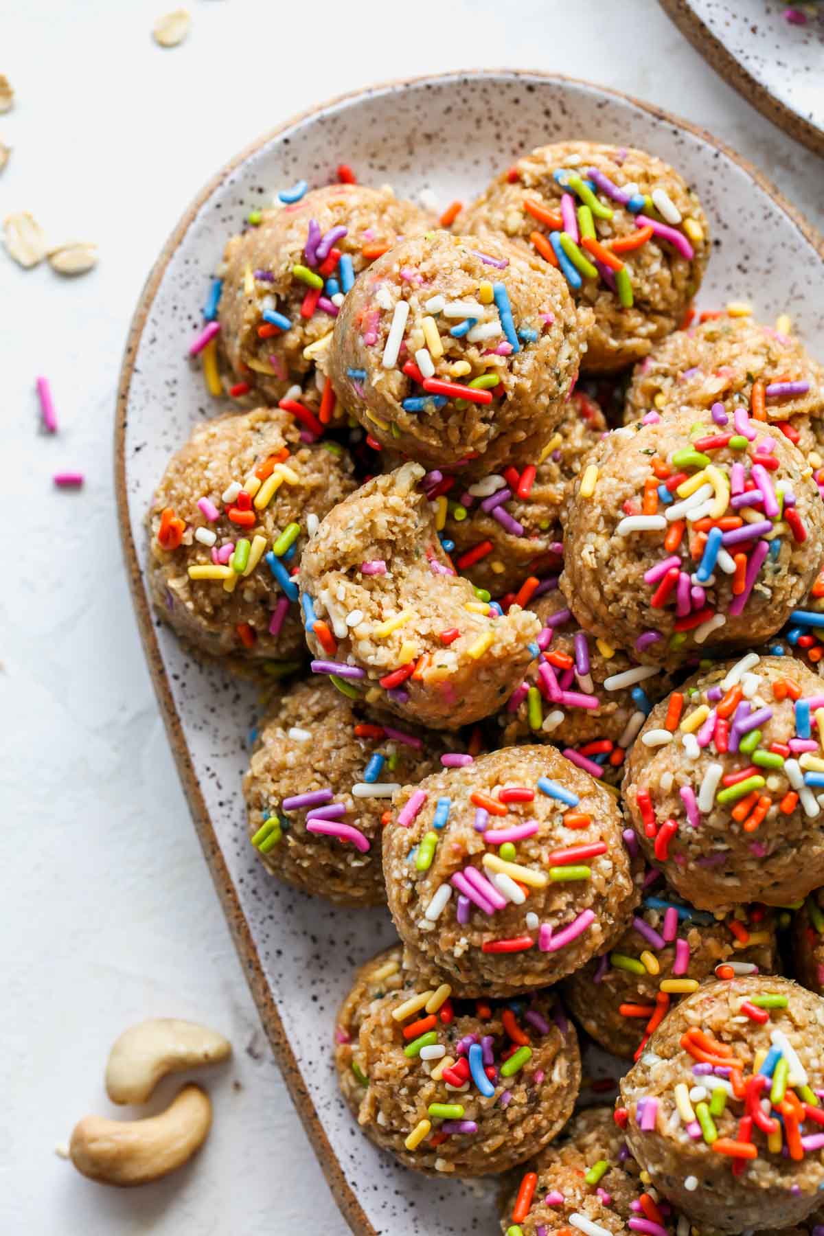 Birthday Cake Protein Ball with a bite taken out to show inside texture