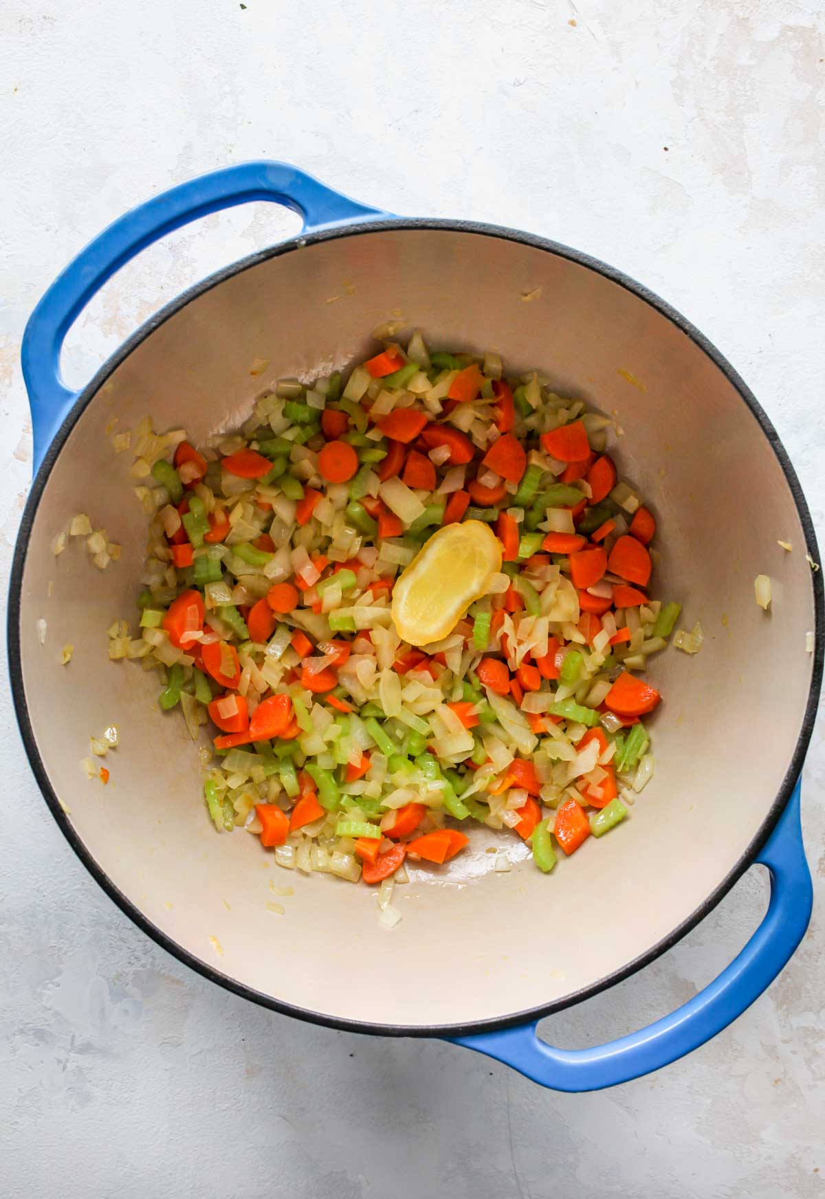 Onion, carrots, and celery sautéing in a pot