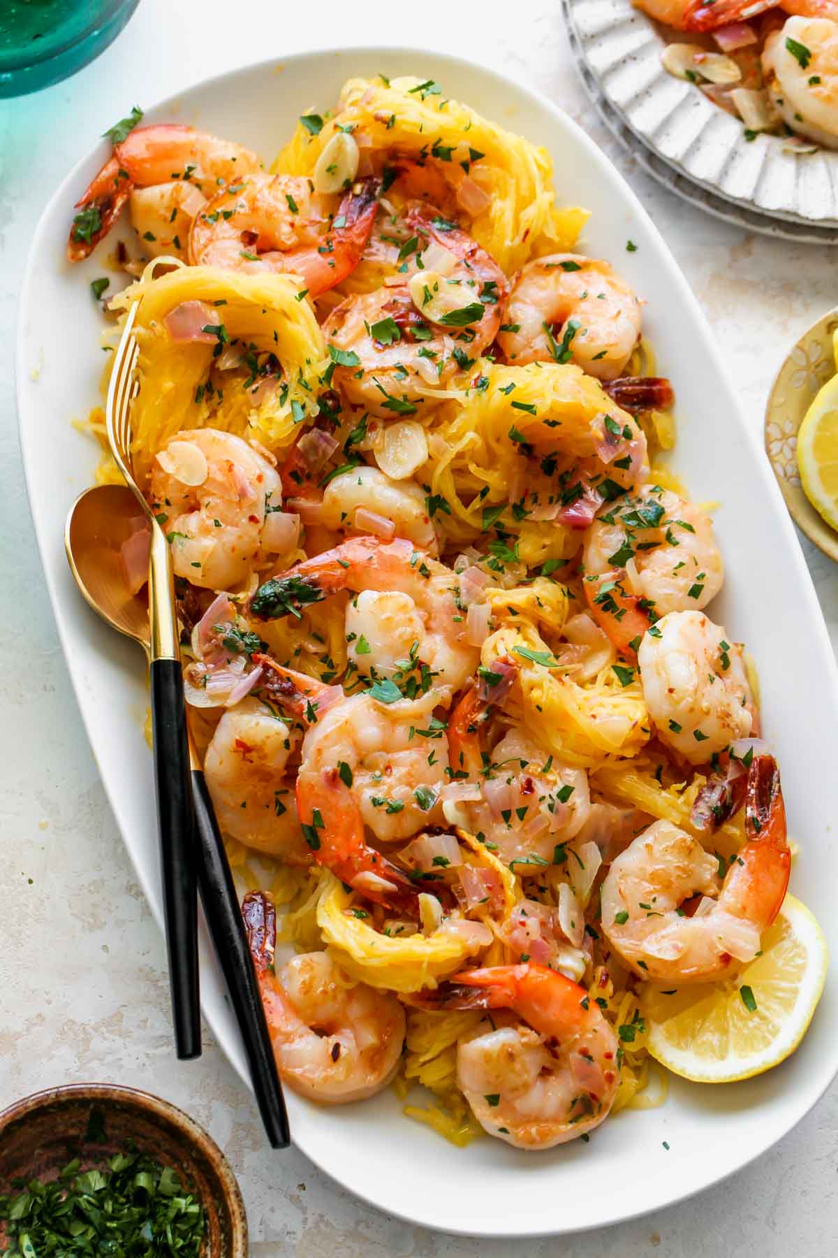 Shrimp Scampi Spaghetti Squash being served on a platter with serving utensils