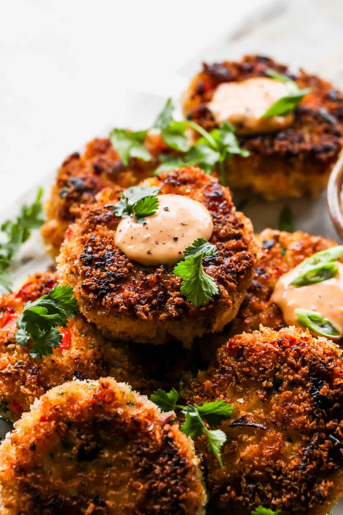 Close up of Thai shrimp cake topped with chili aioli