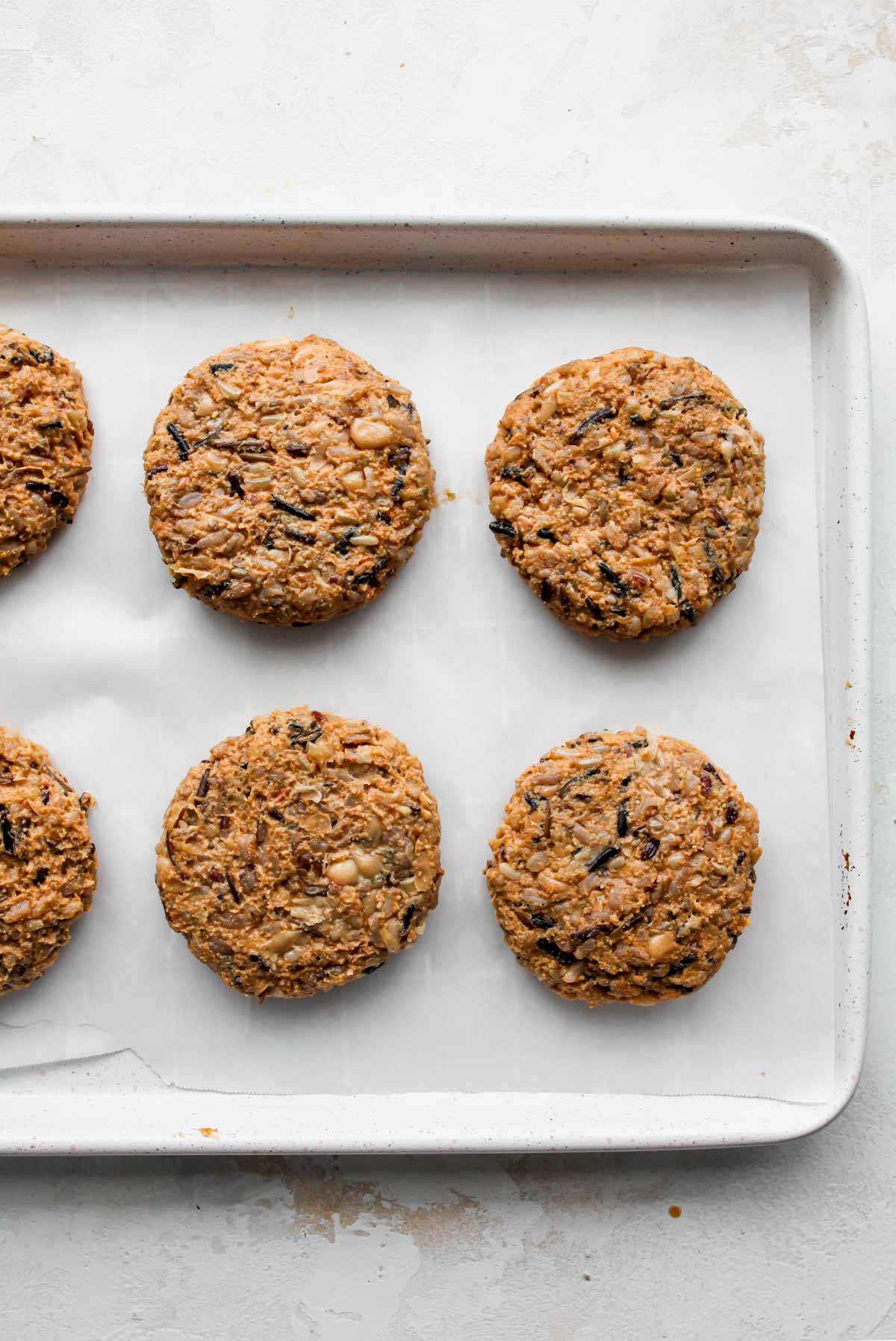 Veggie burger mixture being formed into 8 patties and placed on a baking sheet