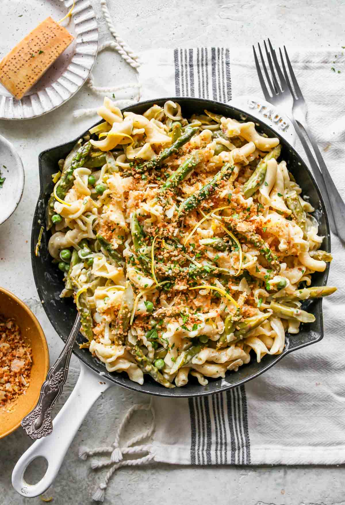 White skillet filled with prepared lemon asparagus pasta and breadcrumbs