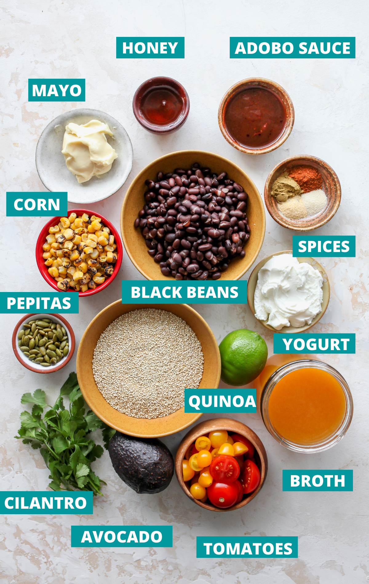 Recipe ingredients in bowls on a white board with blue title tags