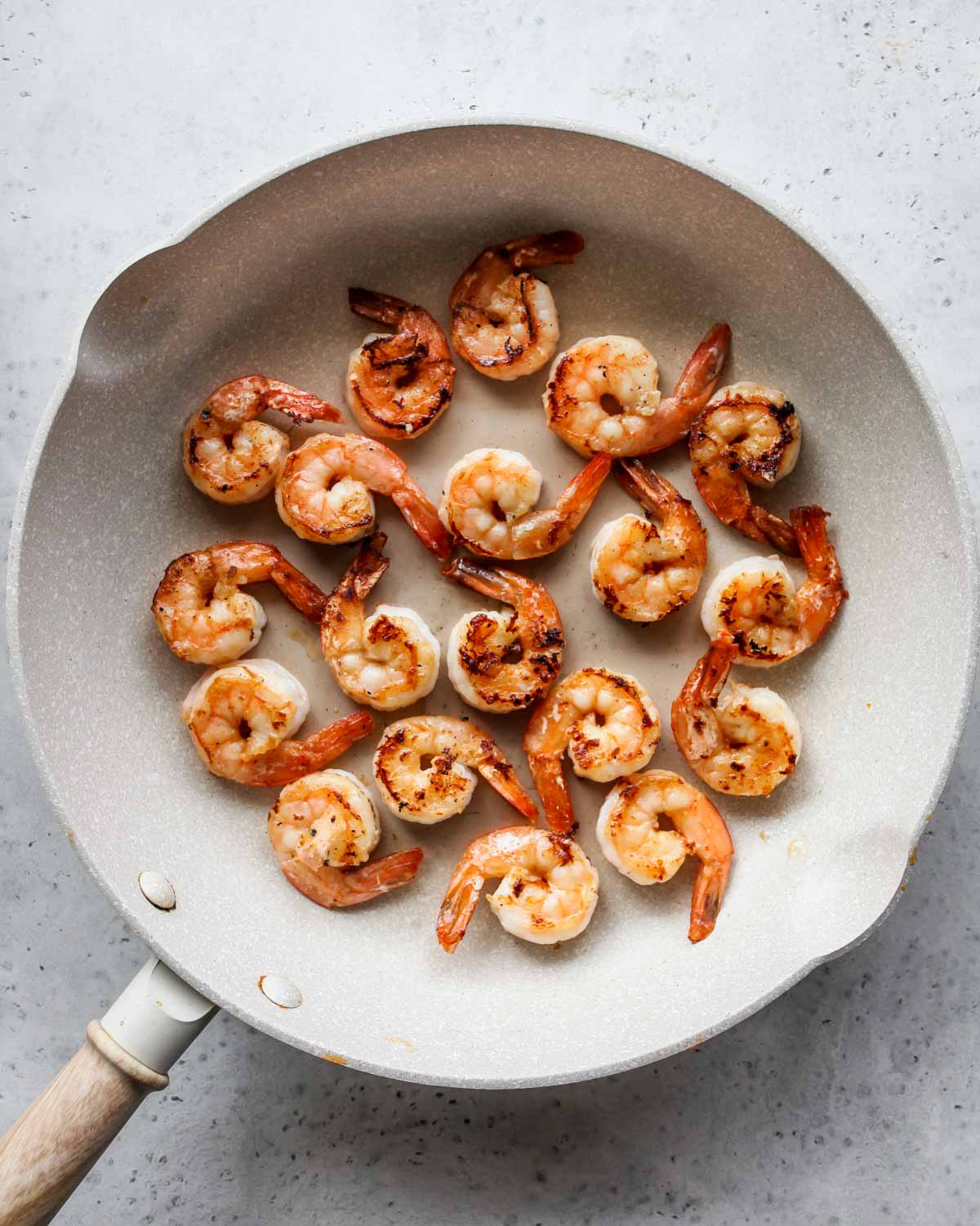 Shrimp sautéing in a skillet